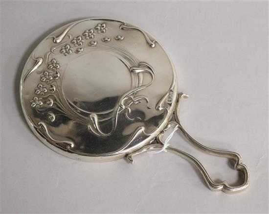 An Edwardian Art Nouveau silver hand mirror with loop handle, Mappin Bros. London, 1902, 22.5cm.